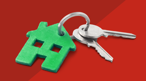 Duas chaves com porta-chaves que ilustra uma casa verde.
